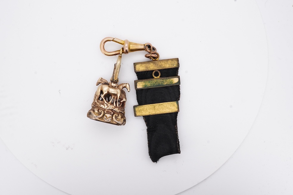 A late Victorian yellow metal overlaid and citrine set watch key fob, depicting two horses and two rams?, 30mm on a black sash suspension, together with a modern pair of 9ct gold and cultured pearl set leaf ear studs. Co